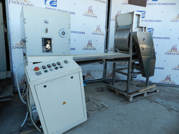 Forming machine for hard candied roasted nuts mass